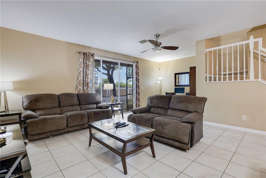 Cream-toned wall paint with white trim, tile flooring, and a ceiling fan with integrated lighting