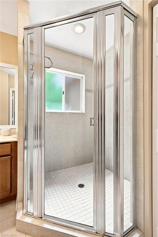 Corner shower enclosure featuring clear glass panels and chrome framing