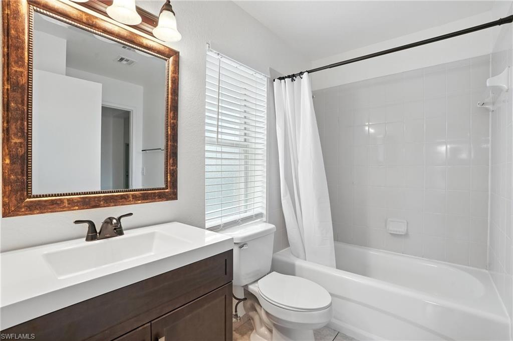 Full bathroom with vanity and shower / bath combo with shower curtain