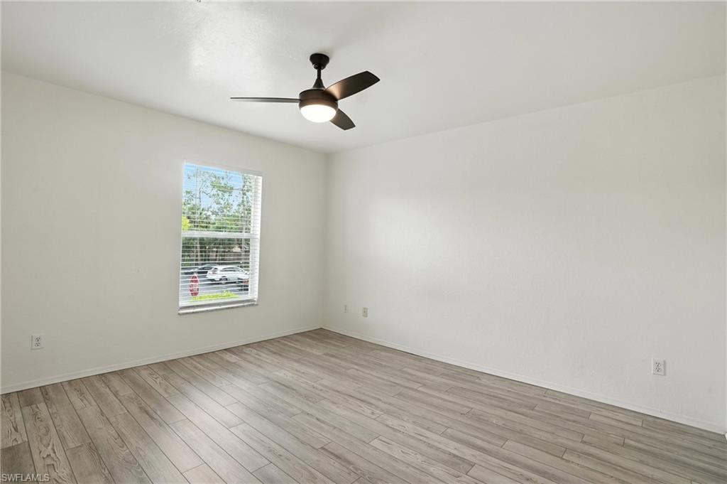 Spare room with light wood-style flooring and a ceiling fan