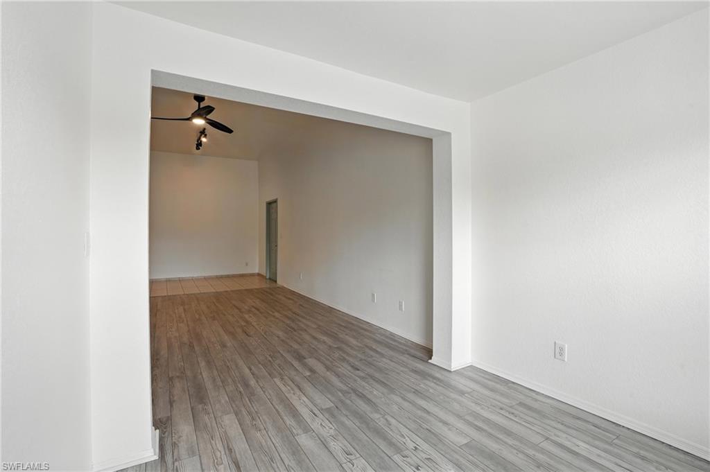 Unfurnished room featuring wood finished floors and ceiling fan