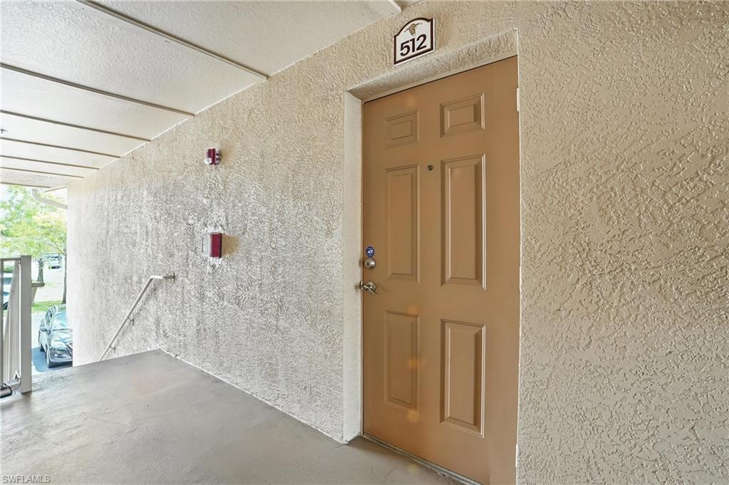 Entrance to property with stucco siding