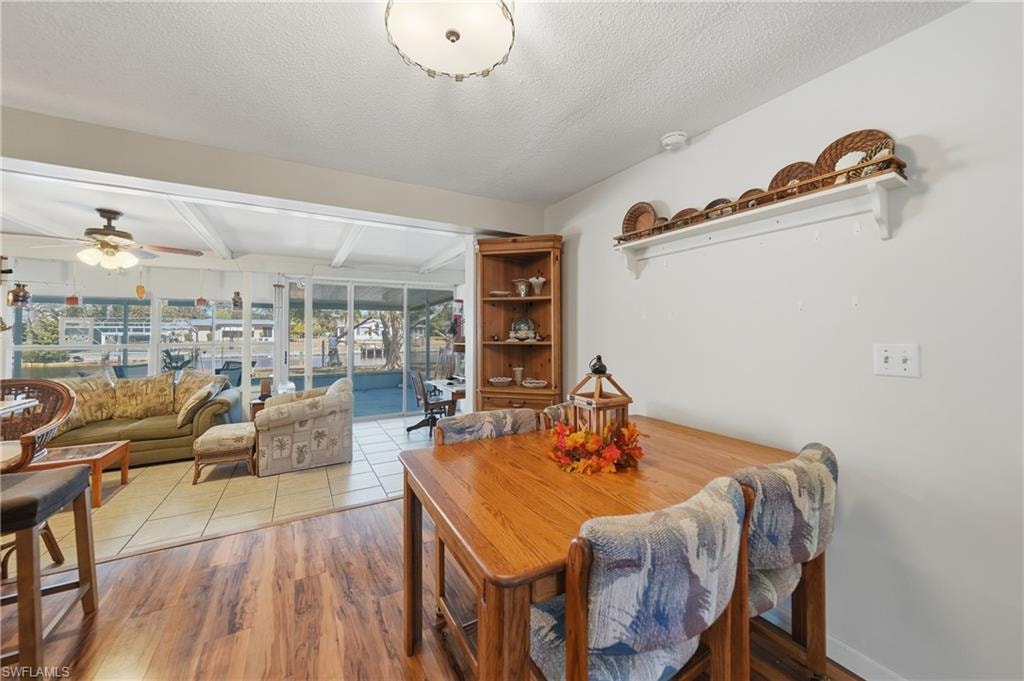 Wood-finish laminate flooring leading to tile in the sunroom