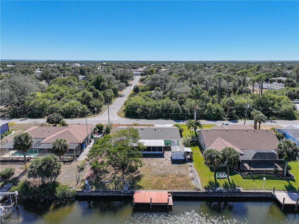 Waterfront property featuring a private dock, direct canal access, and ample green space
