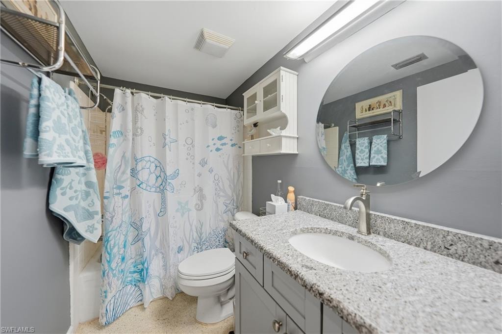 Guest Bath: Vanity with a granite countertop and an undermount sink