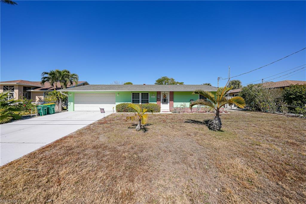 Single-story residence featuring a two-car garage and a paved driveway