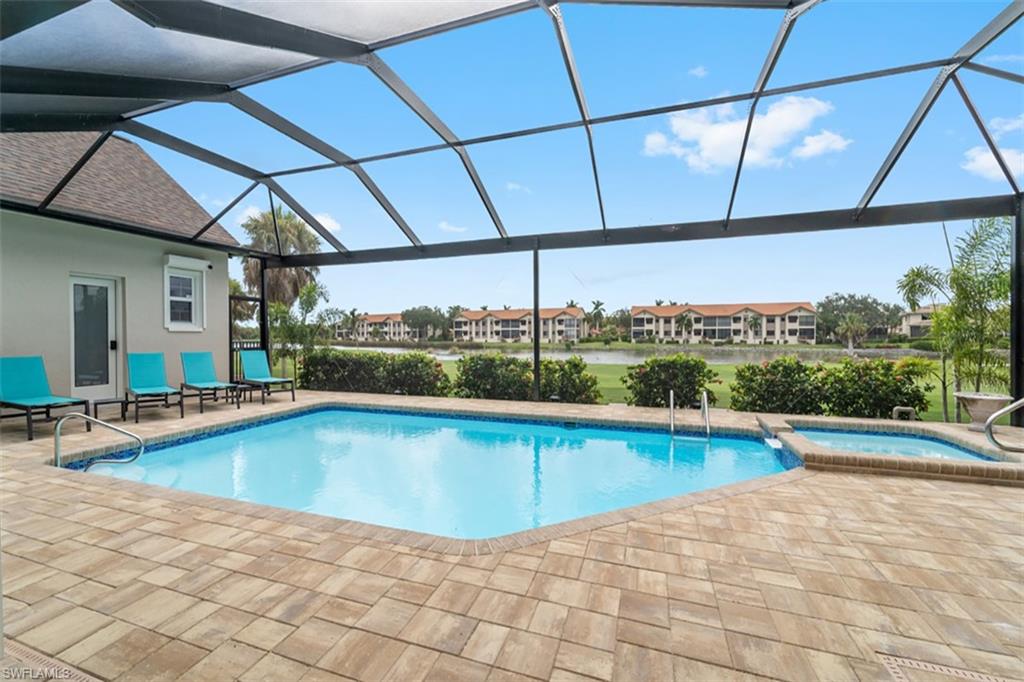 Screened-in outdoor pool and spa with paver patio