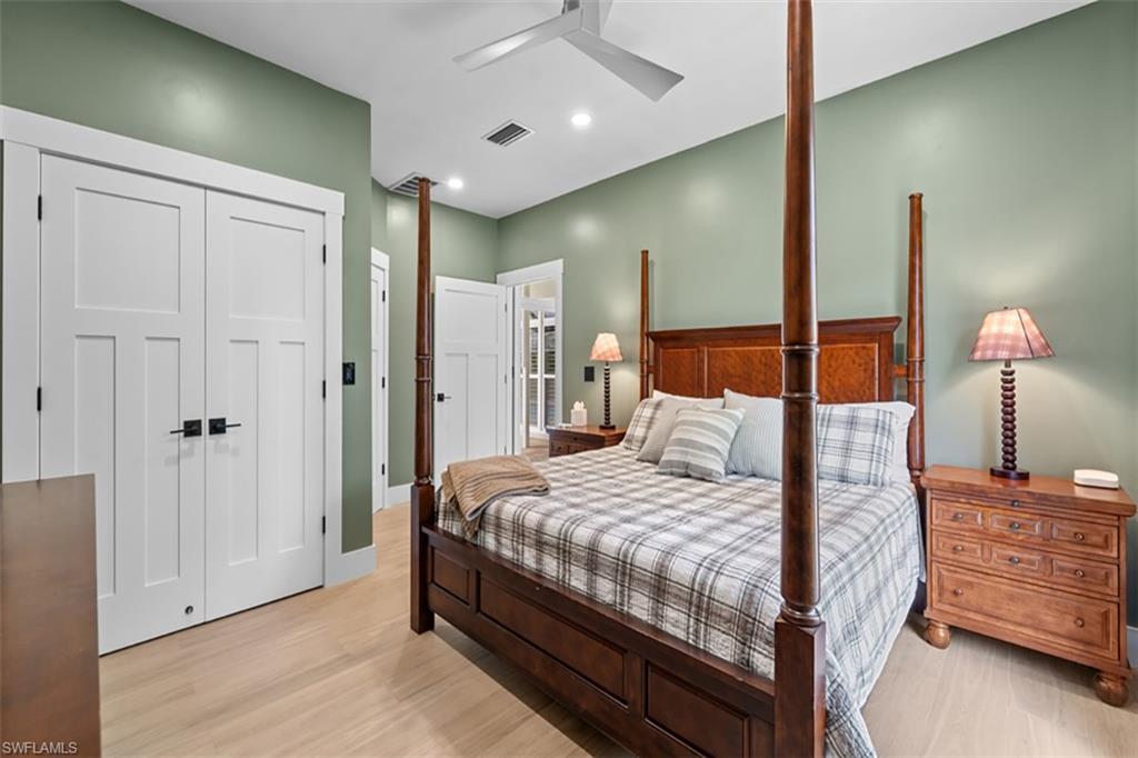 4TH Expansive windows with transom details, light wood-finish flooring, recessed lighting, ceiling fan, and a solid core interior door with matte black hardware
