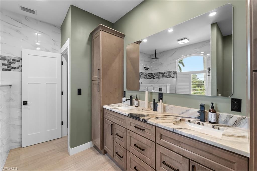 BATH 2 Vanity with a single undermount sink, stone countertop, and matte black faucet