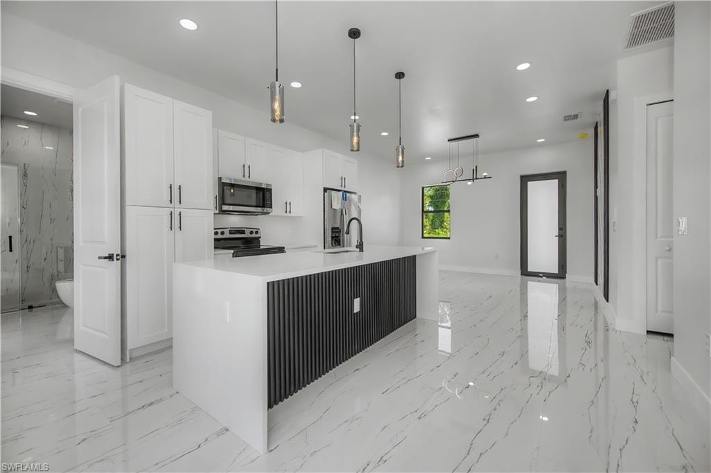 White shaker cabinetry with dark hardware