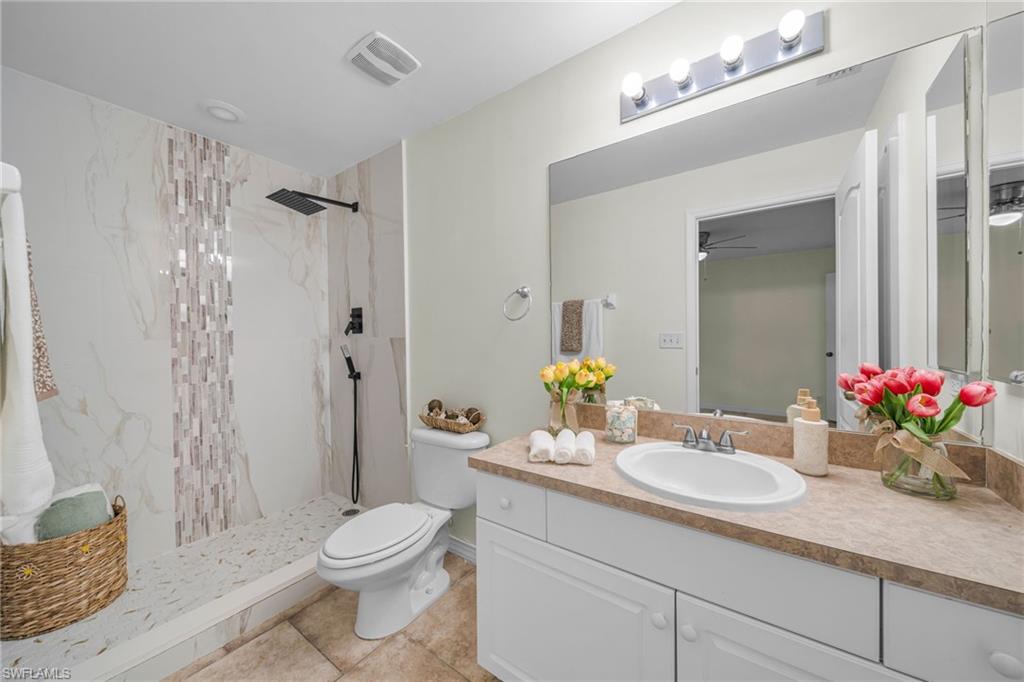 Shower with large format wall tile, mosaic accent, and matte black fixtures