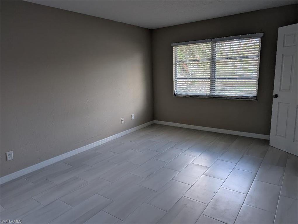 Spare room featuring baseboards