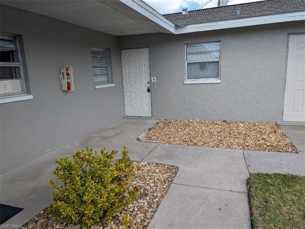 Property entrance with stucco siding