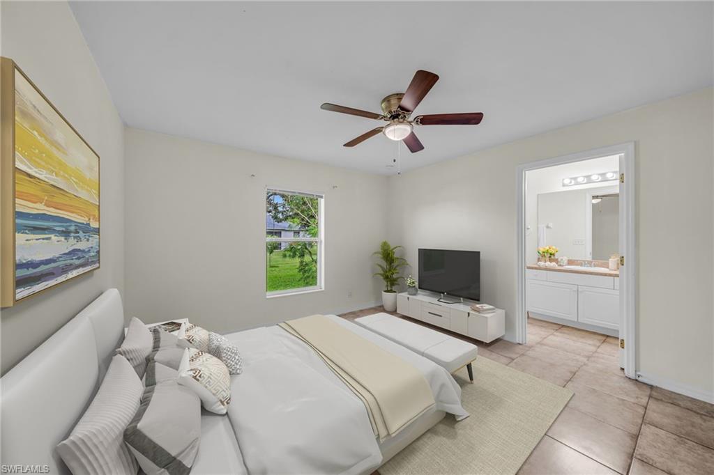 Ceiling fan with integrated lighting, window providing natural light, ceramic tile flooring, and a vanity with a large mirror and overhead lighting