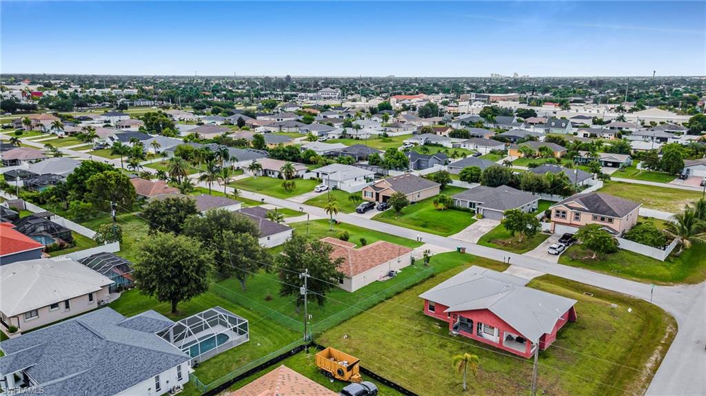 Expansive residential area featuring single-story homes, established landscaping, and a clear sky backdrop