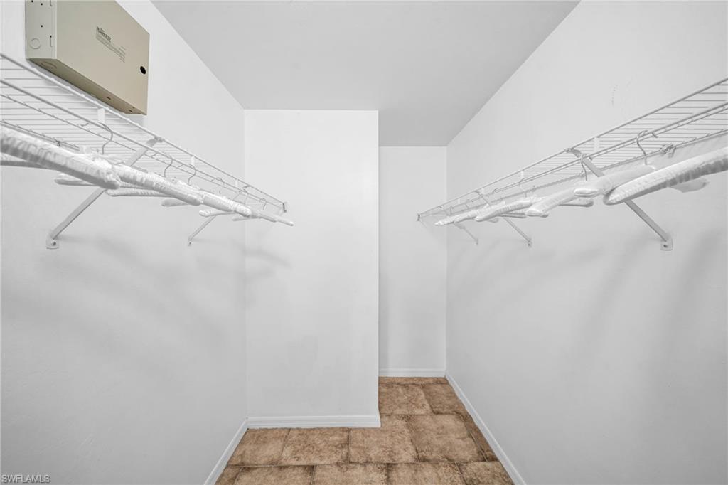 Walk-in closet with wire shelving and tile flooring