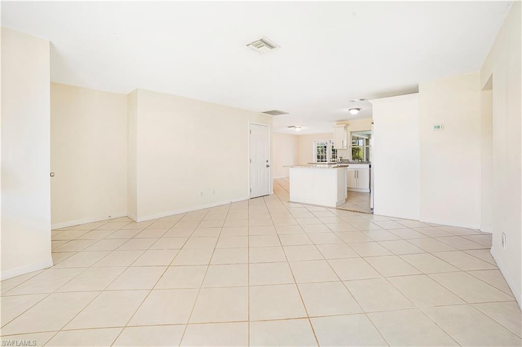 Unfurnished living room featuring light tile patterned floors