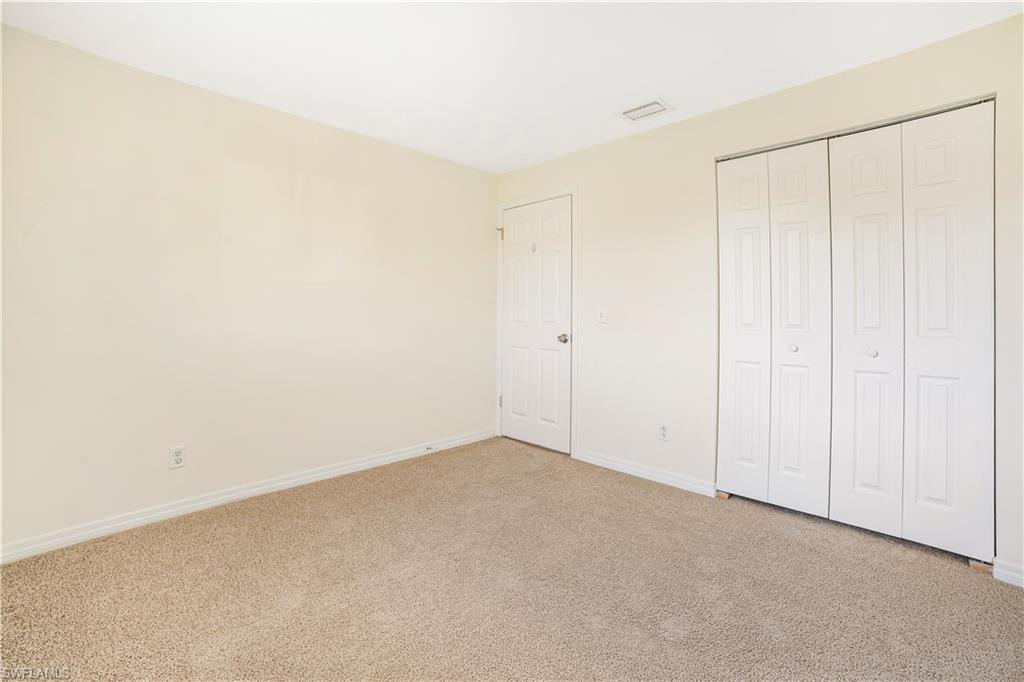 Unfurnished bedroom featuring carpet and a closet