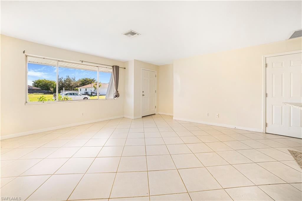 Spare room featuring light tile patterned floors