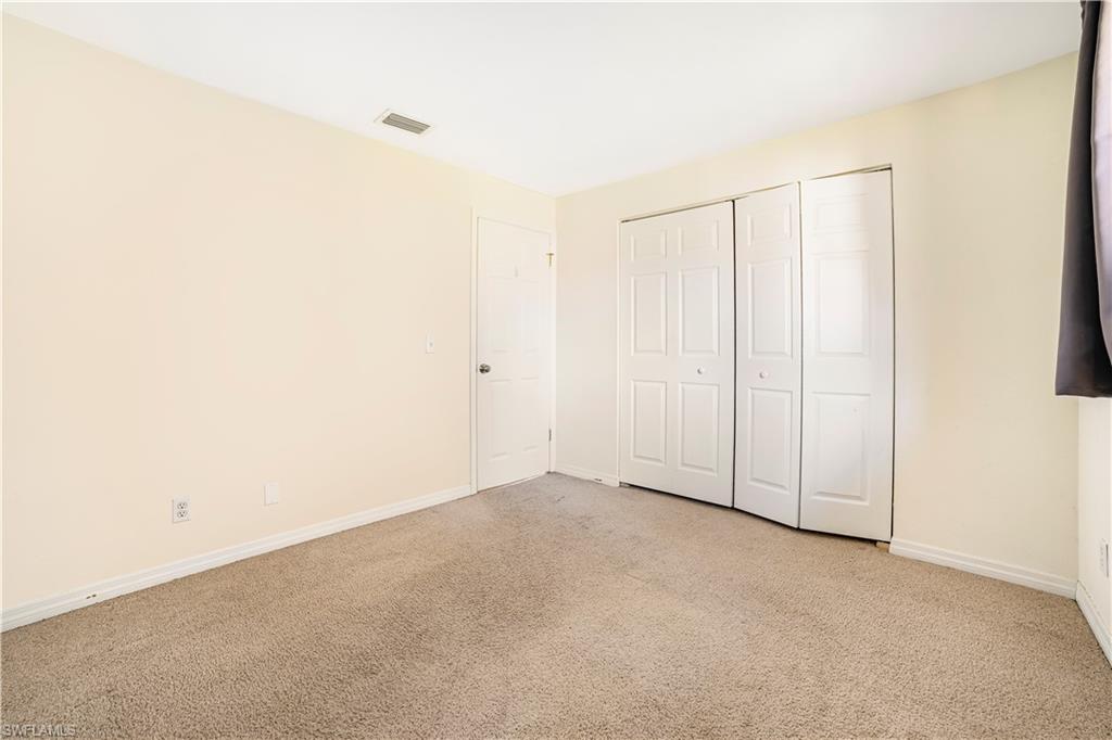 Unfurnished bedroom with a closet and light colored carpet