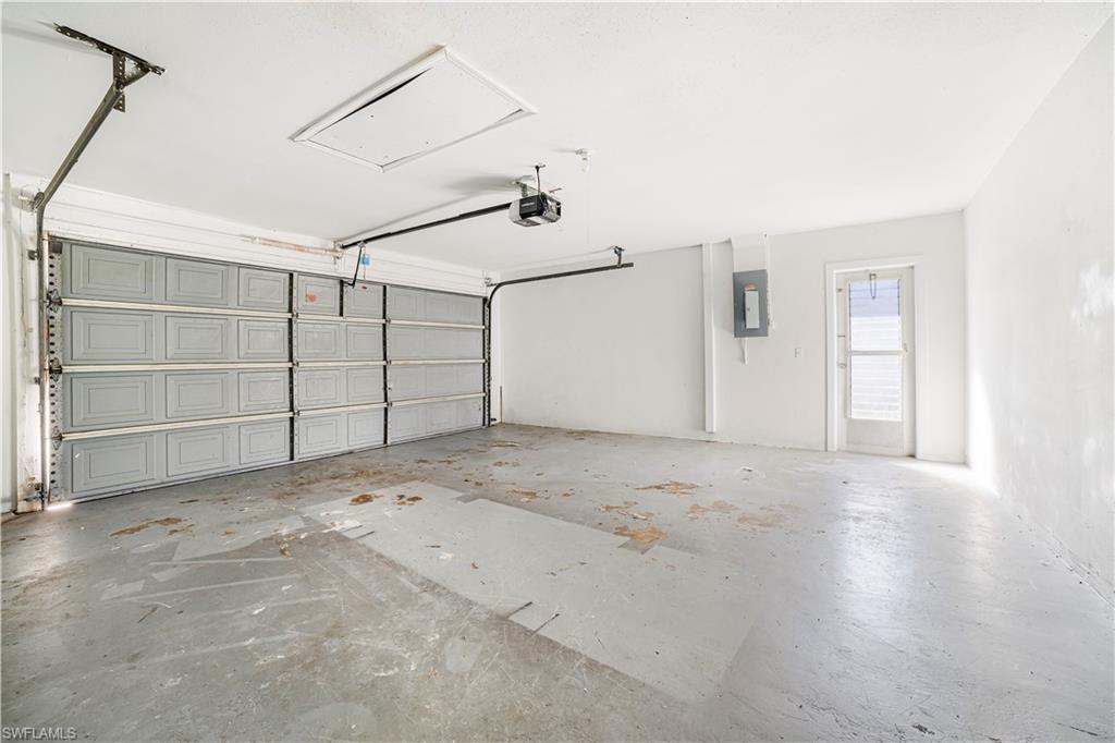 Garage with electric panel and a garage door opener
