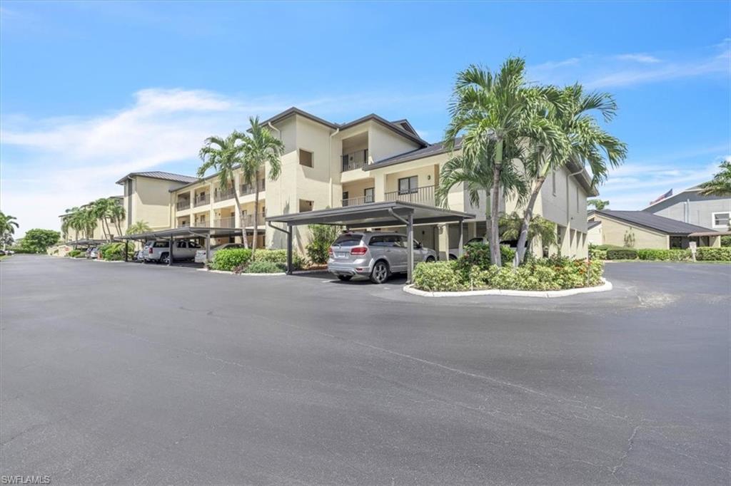 Multi-story residential building with private balconies and covered parking