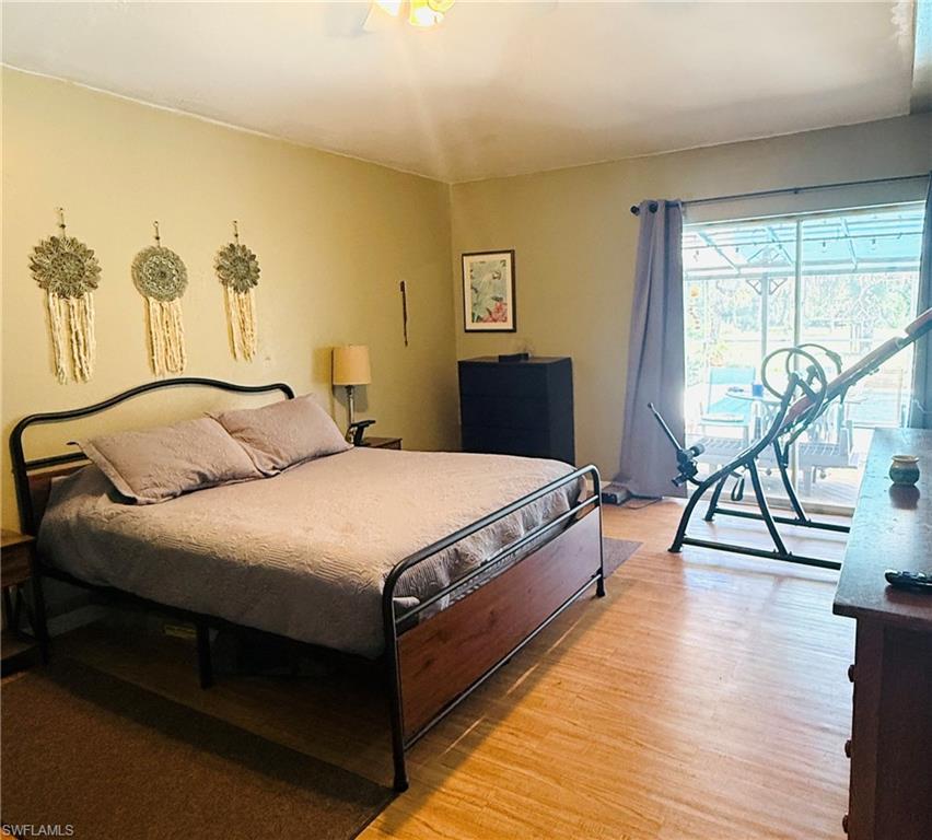 Wood-finish flooring, sliding glass door, and a ceiling fan