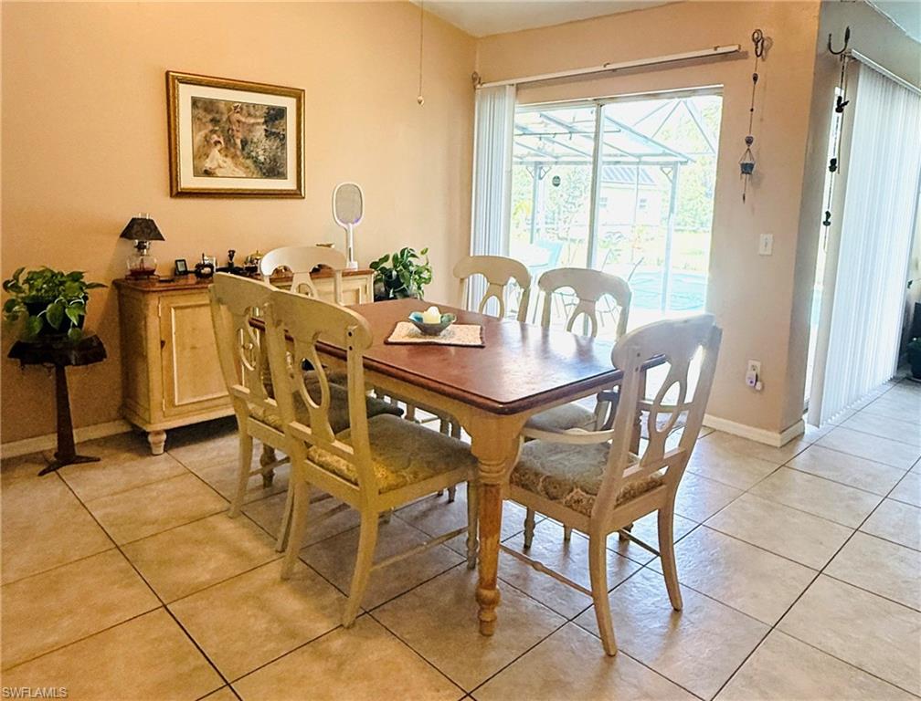 Tiled flooring throughout, sliding glass doors to the exterior, and a built-in ceiling fan