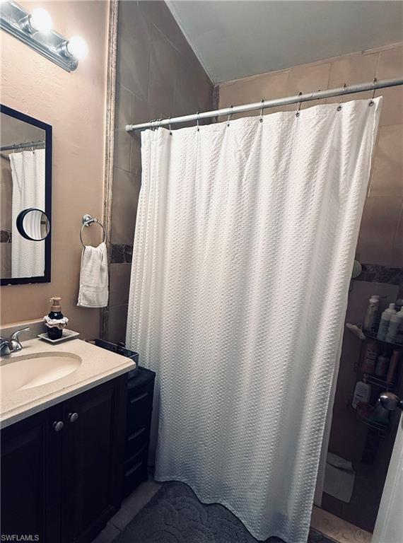 Vanity with a built-in sink, under-sink storage, and a light-colored countertop