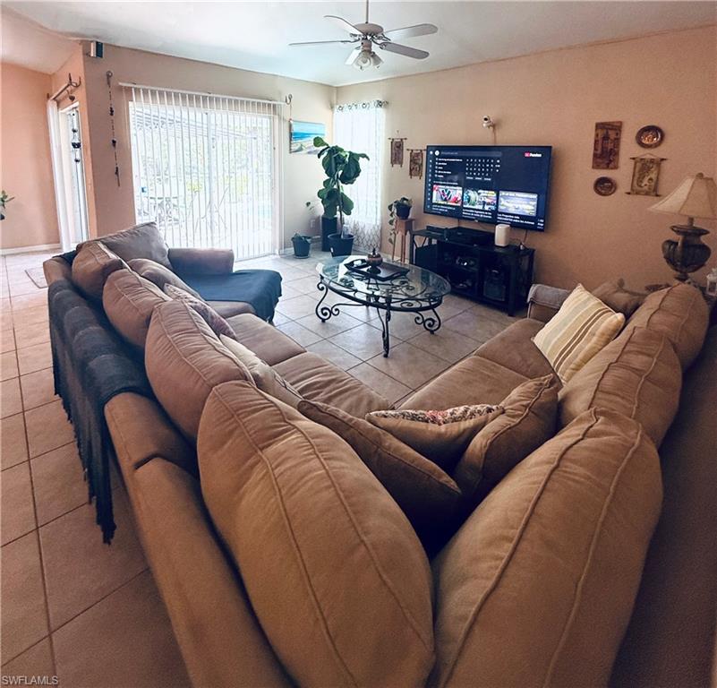 Ceramic tile flooring, ceiling fan, and vertical blinds