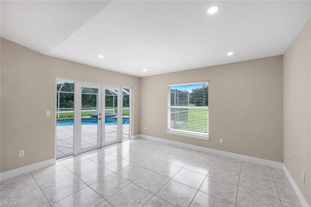 Recessed lighting illuminates the tiled flooring and neutral wall tones