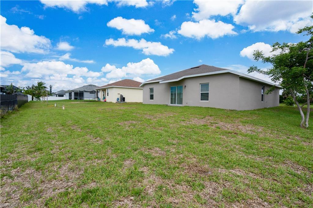 Expansive grassy yard with mature trees