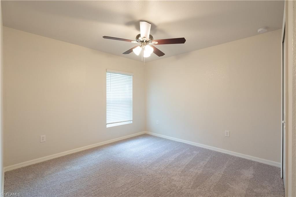 Neutral-toned walls complement the carpeted flooring