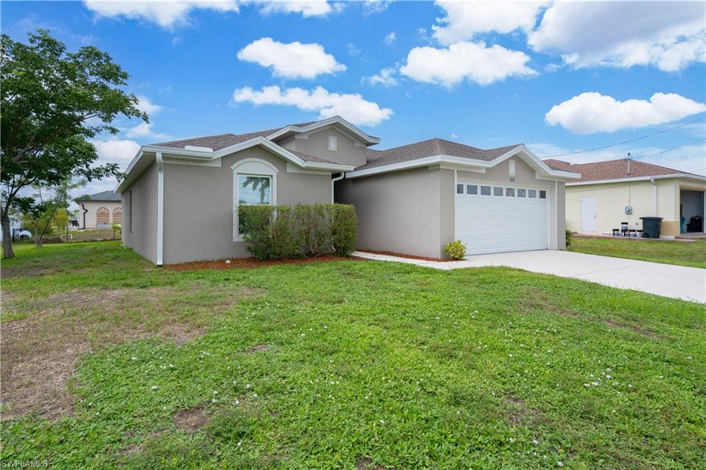 Contemporary stucco exterior with an attached garage, a white garage door, and a concrete driveway