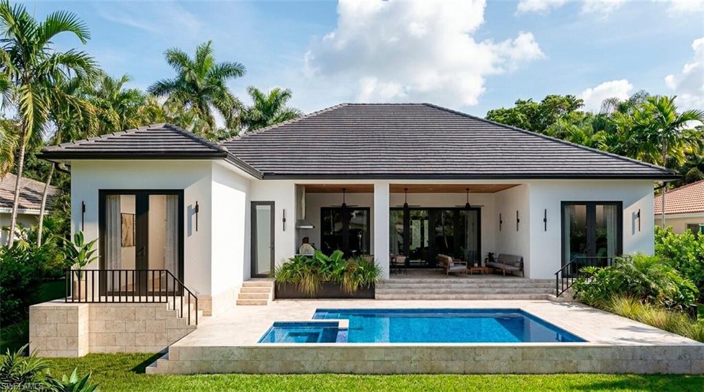 (Rendered photo) Contemporary exterior with a dark tile roof, white stucco facade, private swimming pool, and an integrated spa