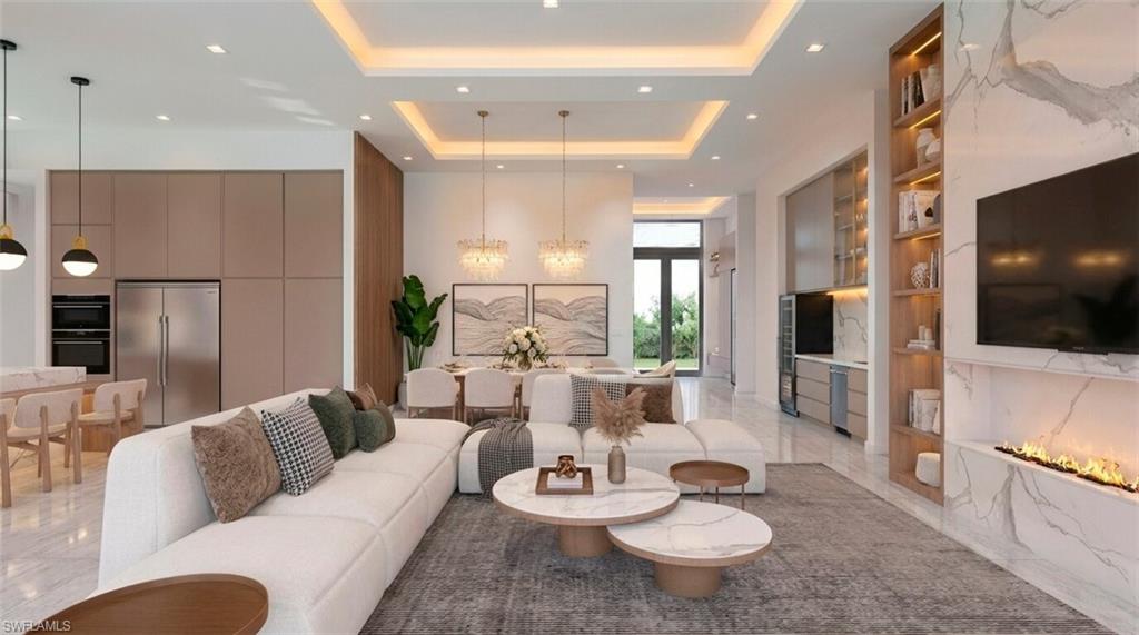(Rendered photo) Integrated living space featuring recessed lighting, a built-in electric fireplace with a stone surround, wood-finish shelving, and a kitchen area with stainless steel appliances