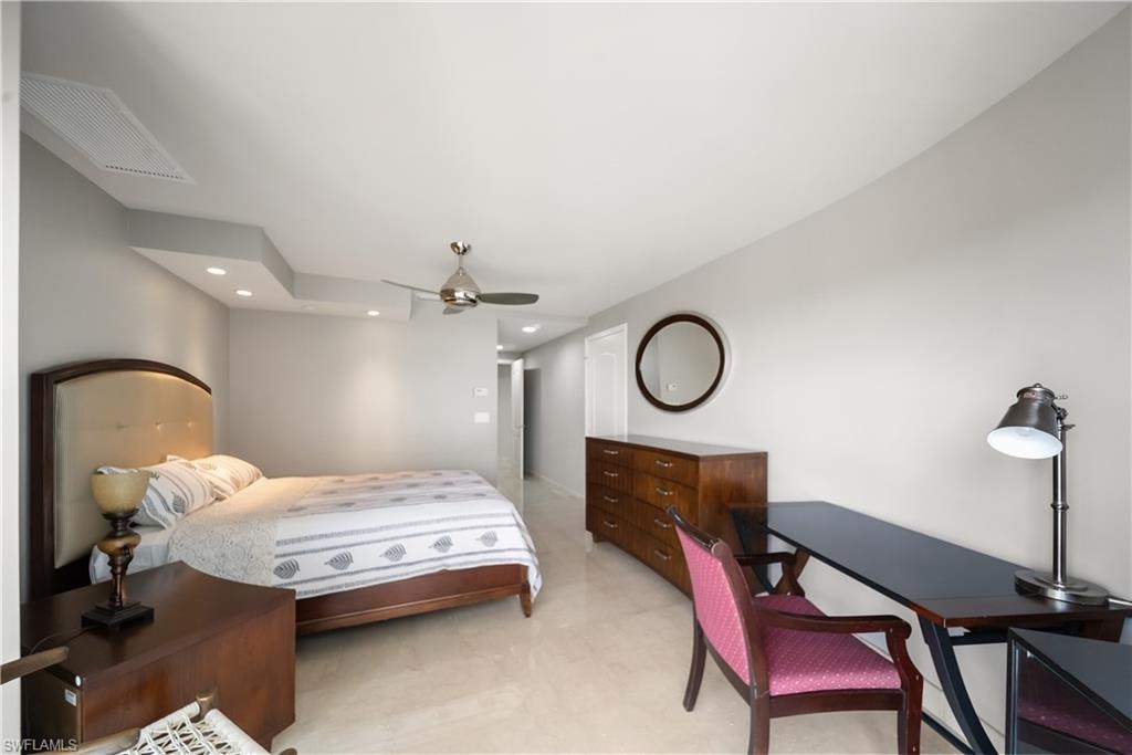 Recessed lighting, ceiling fan, and light-toned flooring