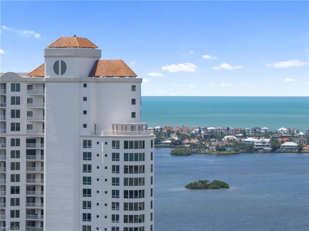 High-rise building with a distinctive architectural cap and multiple balconies
