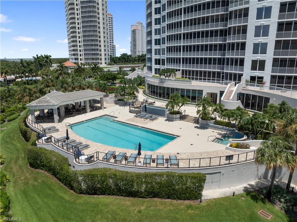 Resort-style pool with integrated spa and surrounding lounge area