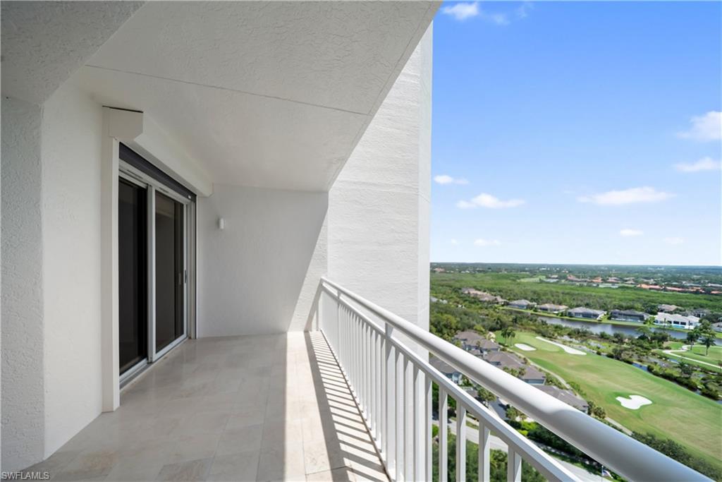 Private balcony with light-toned tile flooring and white metal railing