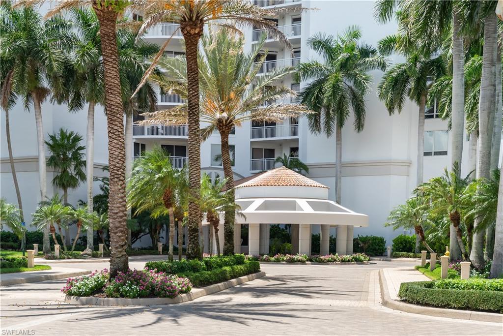 Tropical landscaping with mature palm trees and flowering shrubs