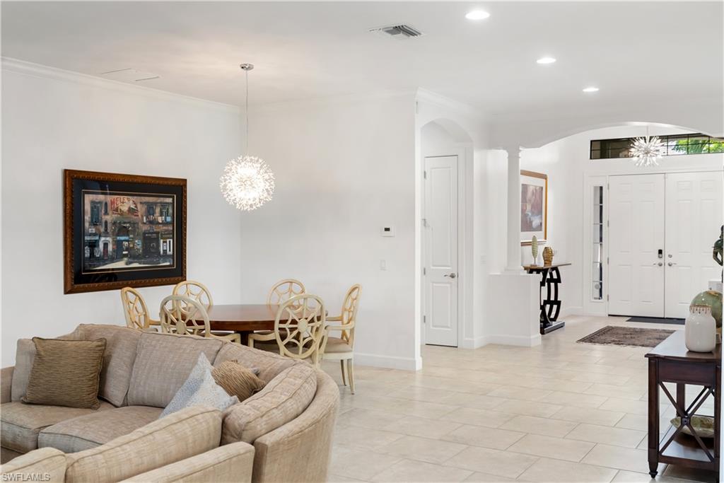 Expansive tiled flooring, recessed lighting, and a decorative pendant light fixture