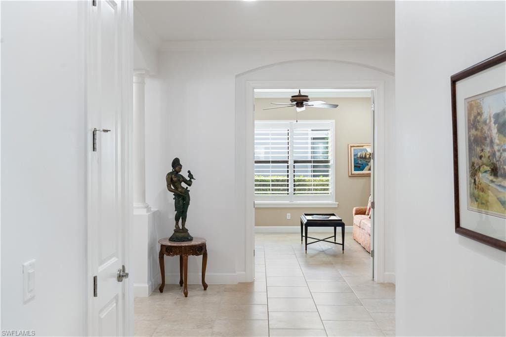 Arched entryway with tile flooring and bright white walls