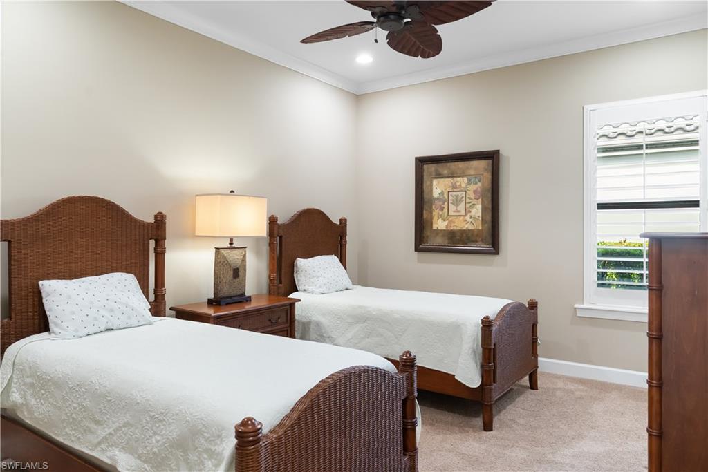 Neutral-toned walls with crown molding, recessed lighting, ceiling fan, and window with plantation shutters