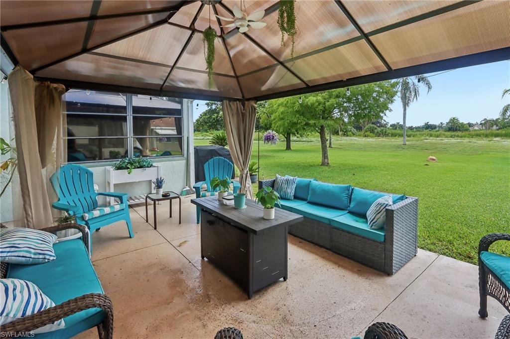 Covered patio with a translucent roof, a ceiling fan, and concrete flooring