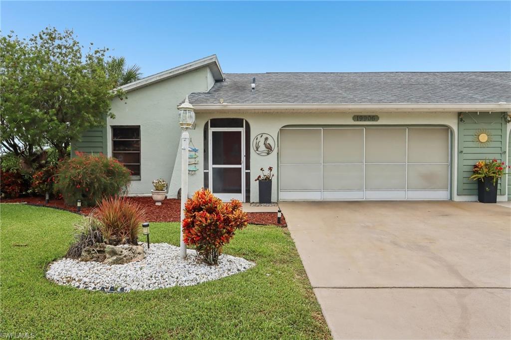 Paved driveway leading to an enclosed two-car garage