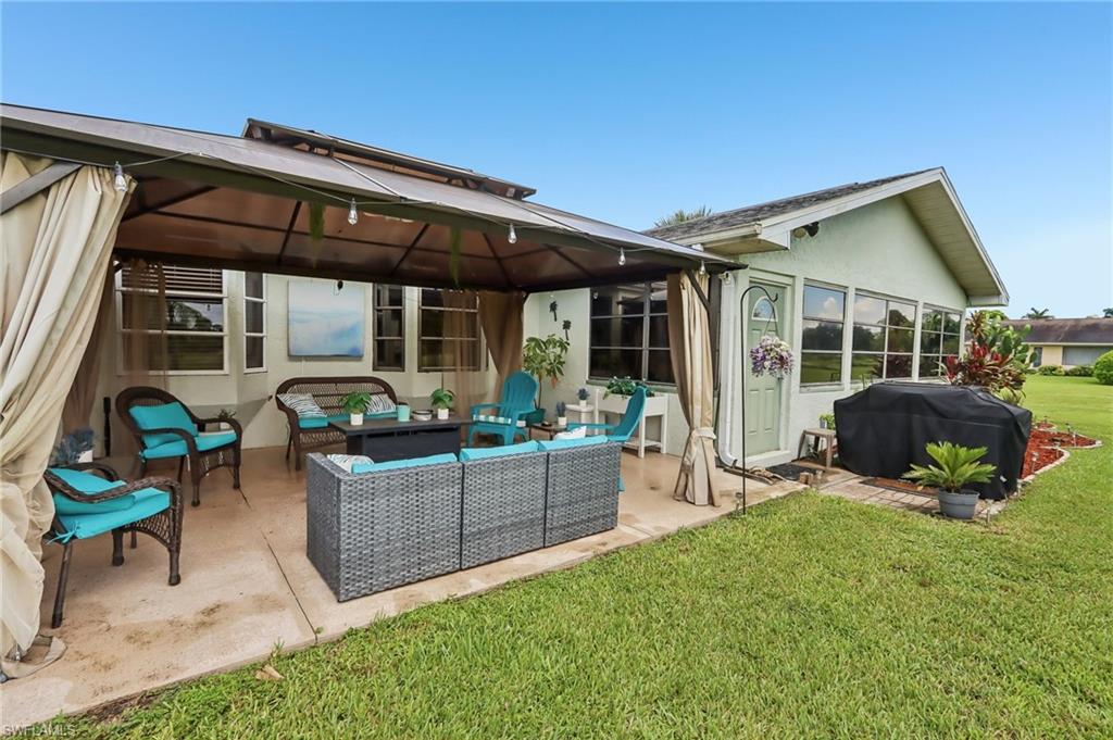 Covered outdoor patio with a concrete slab, screening, and an enclosed sunroom extension