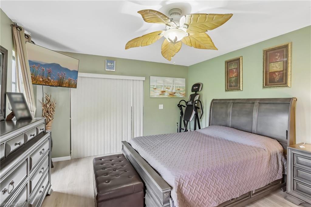 Recessed lighting, wood-finish flooring, and a ceiling fan with leaf-shaped blades