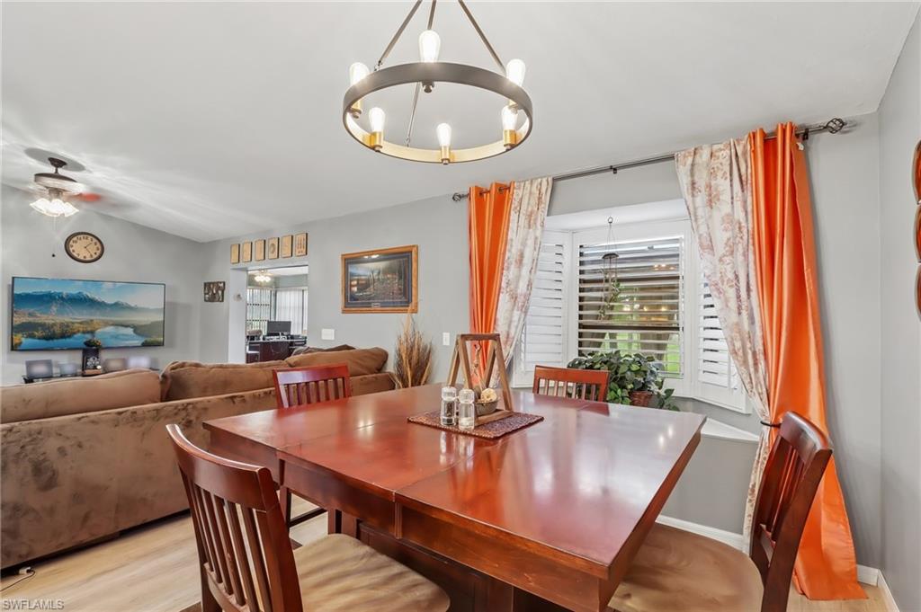 Dining area featuring a modern chandelier and wood-finish flooring
