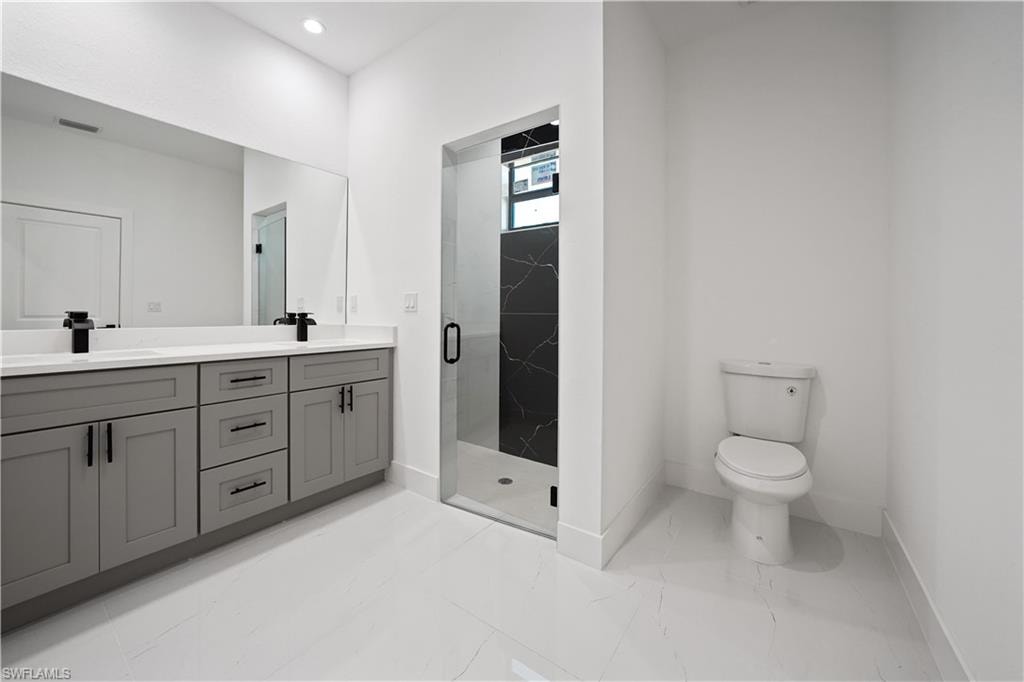 Dual vanity with gray cabinetry and matte black hardware